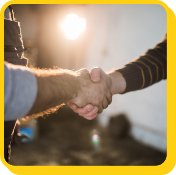 a worker and a home owner shaking hands