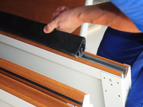 Installation of the weatherproofing on a garage door