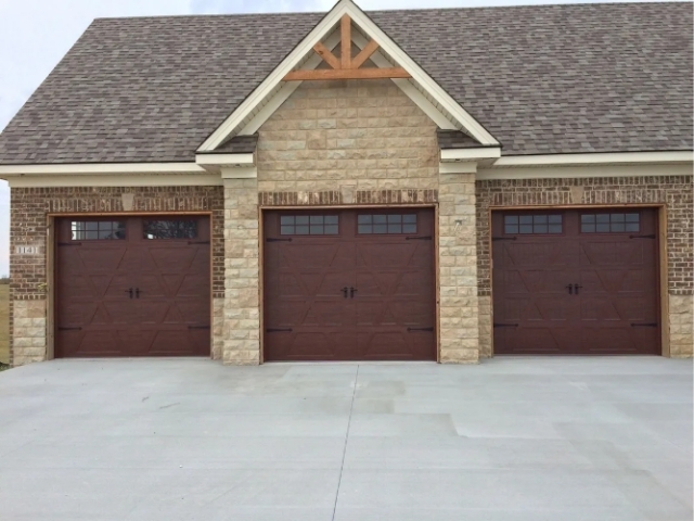 Three Redish Brown Garage Doors with windows