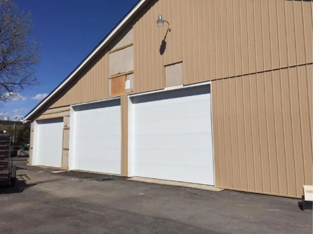 Three White Metal Garage Doors