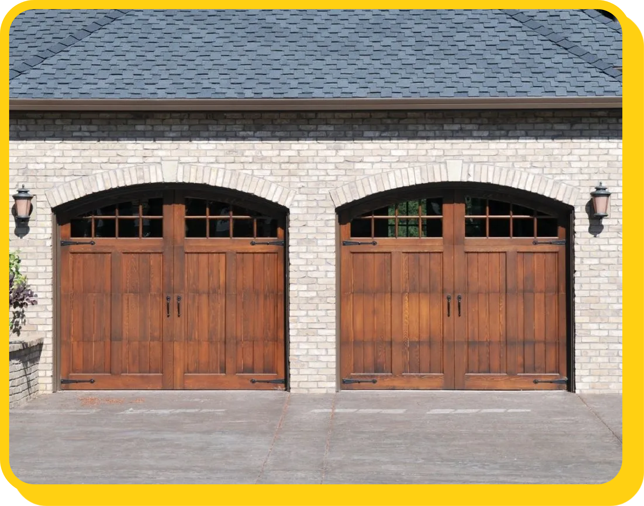 red arched wooden garage doors on a scream brick home